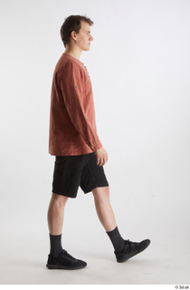  Brett  1 black jeans shorts black sneakers casual dressed orange linen shirt side view walking whole body 0004.jpg